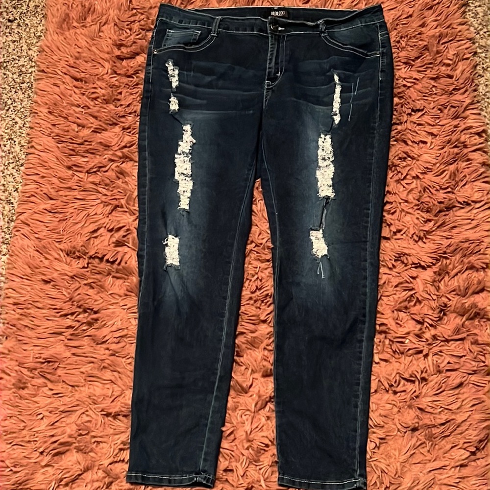 Distressed dark blue jeans
